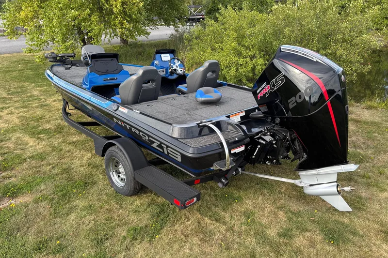 Slide: The Image of 2026 Nitro Z19 XL boat with powerful engine on grassy area. - 2