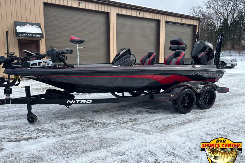 The Image of 2026 Nitro Z19 XL boat on trailer outside D&R Sports Center in snowy setting. - 0