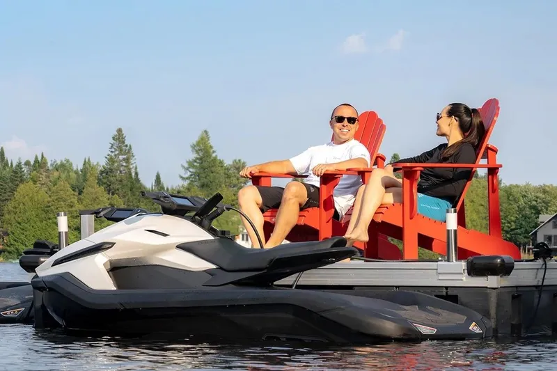 Slide: The Image of Couple relaxing on dock with 2025 Taiga Orca P2 jet ski, surrounded by nature. - 15