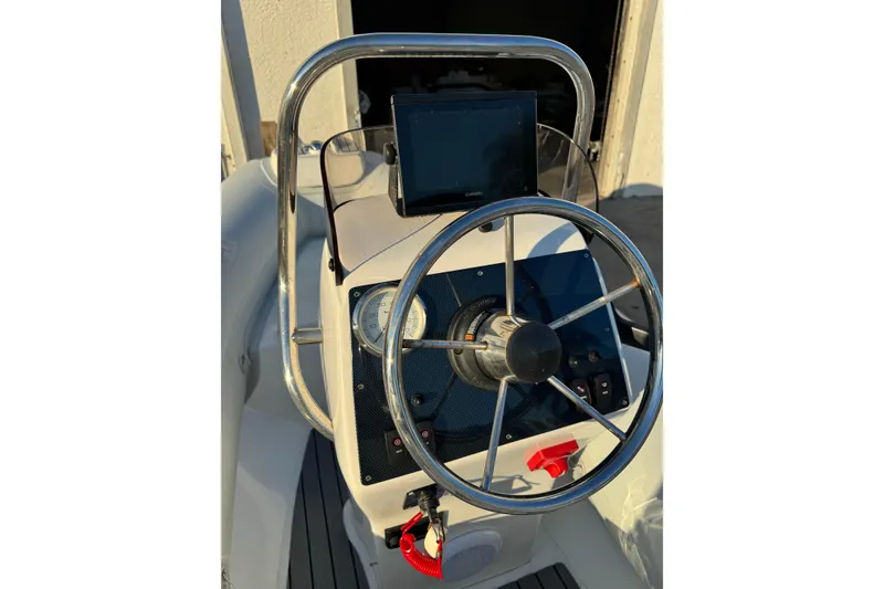 Slide: The Image of 2022 AB Inflatables Alumina 11 ALX boat steering console with gauges and controls. - 10