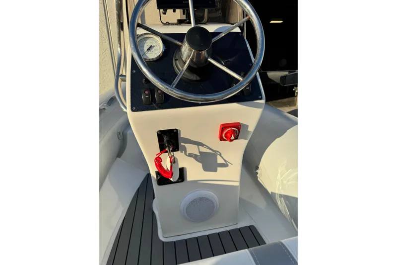 Slide: The Image of 2022 AB Inflatables Alumina 11 ALX boat console with steering wheel and controls. - 11