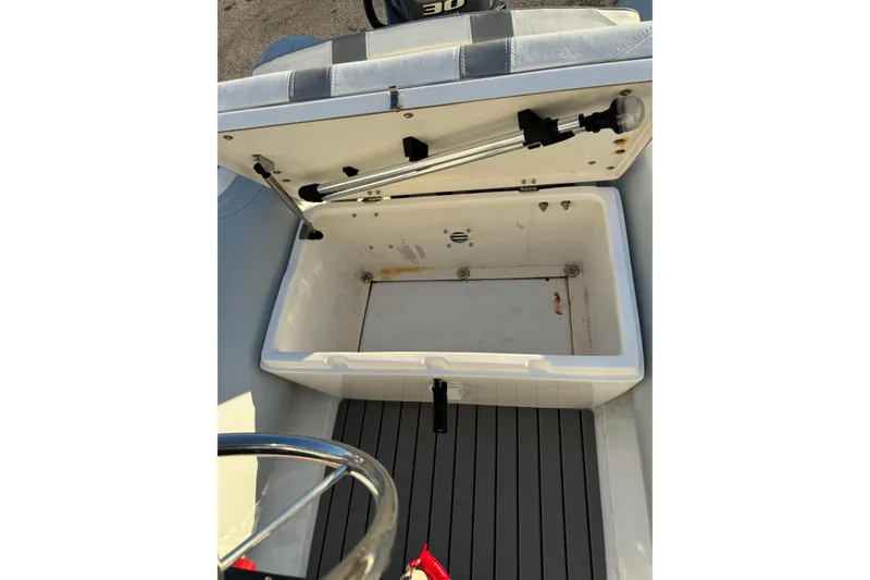 Slide: The Image of 2022 AB Inflatables Alumina 11 ALX boat storage compartment open, showing interior details. - 13