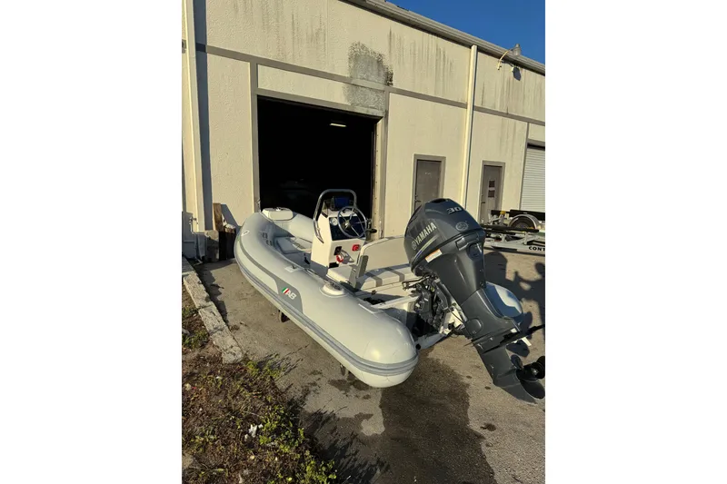 Slide: The Image of 2022 AB Inflatables Alumina 11 ALX boat with Yamaha motor outside a warehouse. - 3