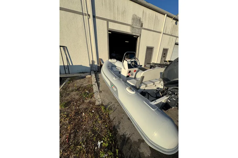 Slide: The Image of 2022 AB Inflatables Alumina 11 ALX boat outside a warehouse, featuring sleek design and modern equipment. - 5