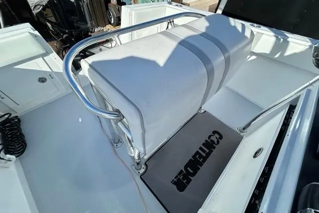 Slide: The Image of 2006 Contender 21 Open boat interior with cushioned seating and stainless steel railing. - 14