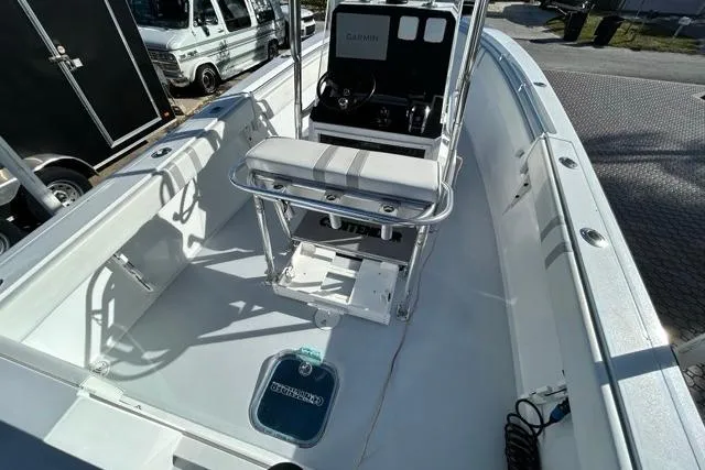 Slide: The Image of 2006 Contender 21 Open boat interior with seating and console, parked outdoors. - 24