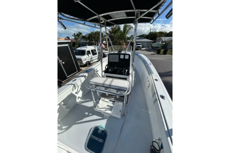 Slide: The Image of 2006 Contender 21 Open boat interior with console and seating, parked outdoors. - 25