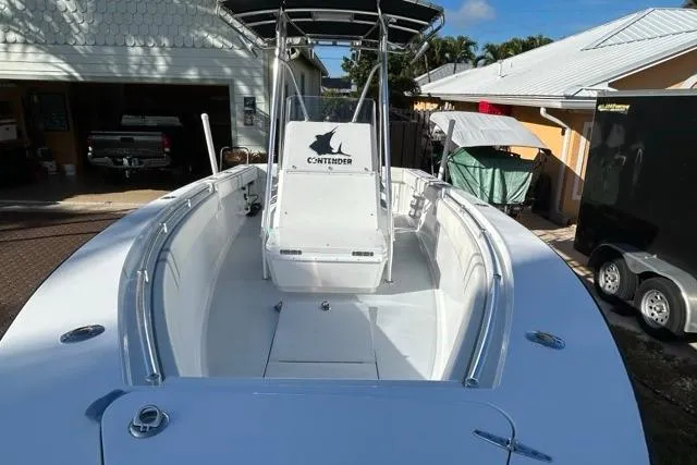 Slide: The Image of 2006 Contender 21 Open boat with center console and T-top in a driveway setting. - 28