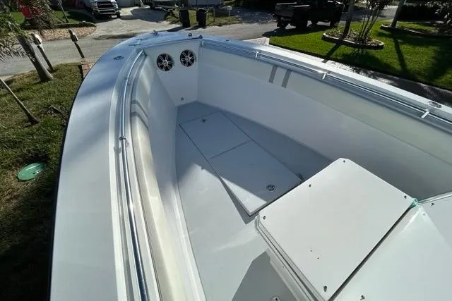 Slide: The Image of 2006 Contender 21 Open boat interior with storage compartments and speakers. - 8