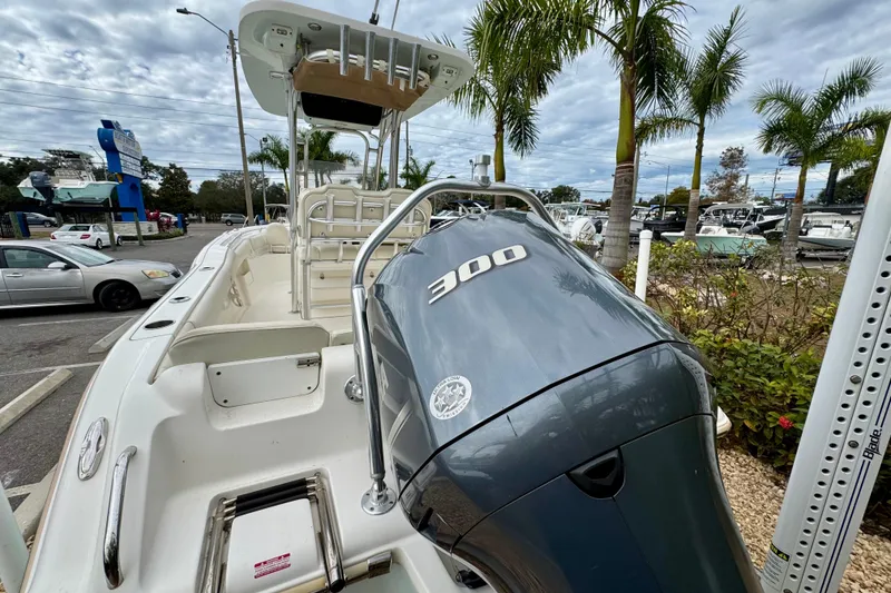 Slide: The Image of 2019 Key West 239 FS boat with powerful 300 HP engine, parked near palm trees. - 10