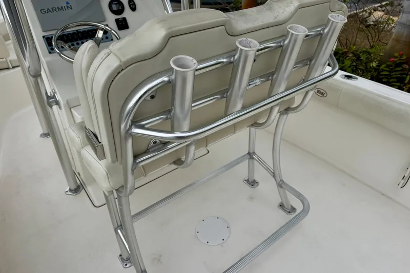 Slide: The Image of 2019 Key West 239 FS boat with rod holders and canopy, surrounded by palm trees. - 14