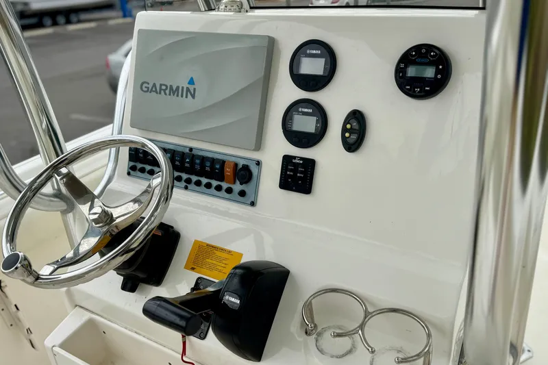 Slide: The Image of 2019 Key West 239 FS boat T-top structure with palm trees in the background. - 18