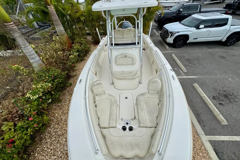 Slide: The Image of 2019 Key West 239 FS boat with white cushioned seating, outdoor setting. - 24