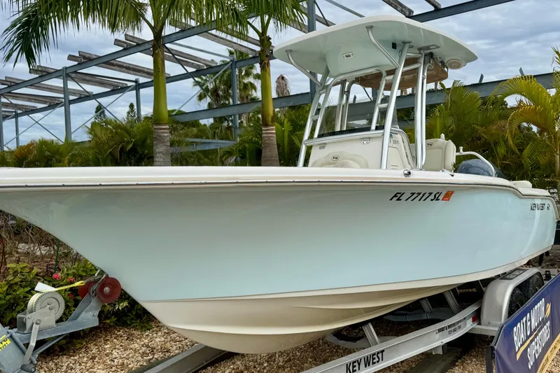 Slide: The Image of 2019 Key West 239 FS boat on trailer, surrounded by palm trees. - 3