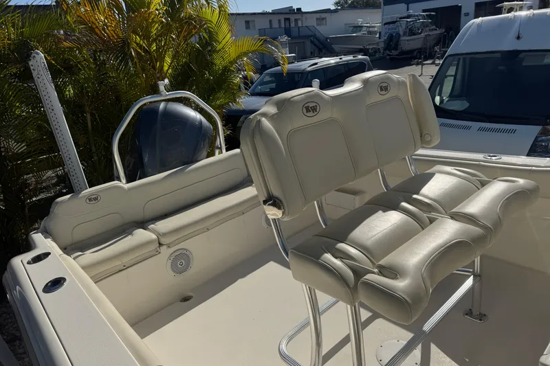 Slide: The Image of 2019 Key West 239 FS boat interior with cushioned seating and helm. - 32