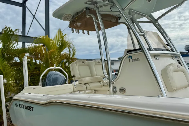 Slide: The Image of 2019 Key West 239 FS boat with sleek design, parked near tropical plants. - 5