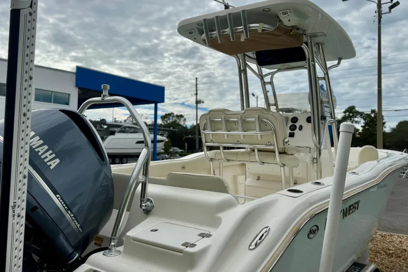 Slide: The Image of 2019 Key West 239 FS boat with Yamaha engine, parked outdoors under cloudy sky. - 7