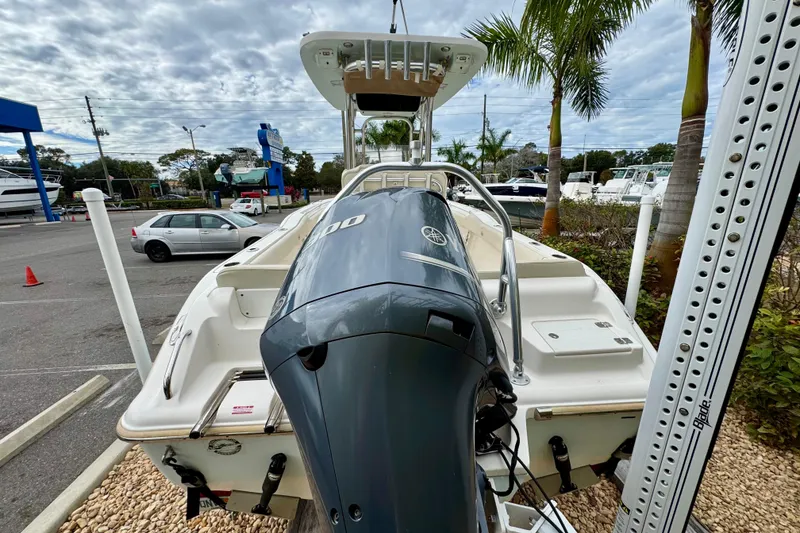 Slide: The Image of 2019 Key West 239 FS boat with Yamaha outboard motor, parked near palm trees. - 9