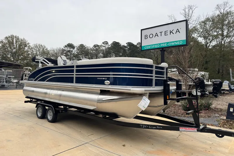 Slide: The Image of 2025 Harris Sunliner 230 pontoon boat on trailer at Boateka, certified pre-owned. - 1