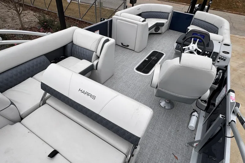 Slide: The Image of 2025 Harris Sunliner 230 pontoon boat interior with plush seating and modern helm. - 6