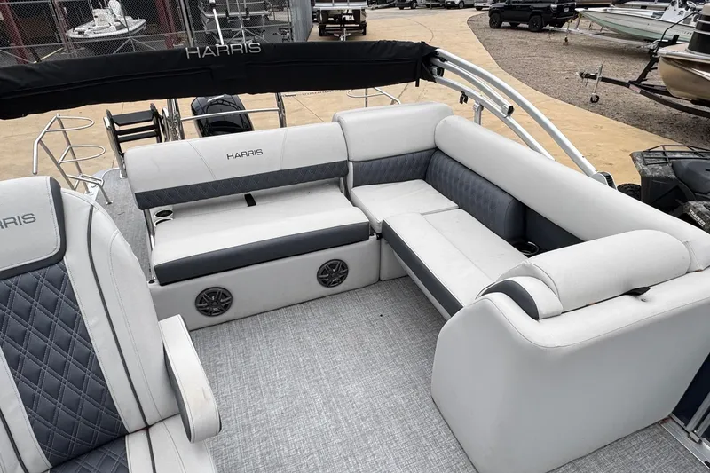 Slide: The Image of 2025 Harris Sunliner 230 pontoon boat interior with plush seating and modern design. - 7