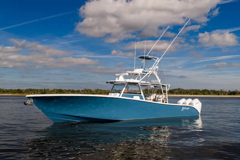 The Image of 2024 Yellowfin 42 Offshore boat on calm water under blue sky. - 0