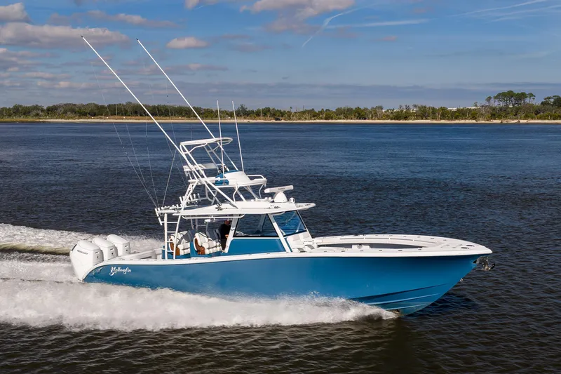 Slide: The Image of 2024 Yellowfin 42 Offshore boat cruising on open water, side view. - 13