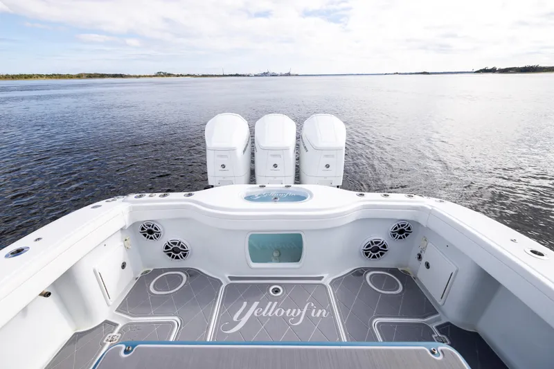 Slide: The Image of 2024 Yellowfin 42 Offshore boat with triple engines on calm water. - 16