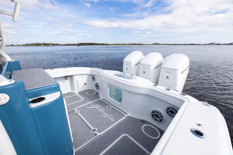 Slide: The Image of 2024 Yellowfin 42 Offshore boat with triple Mercury engines on calm water. - 17