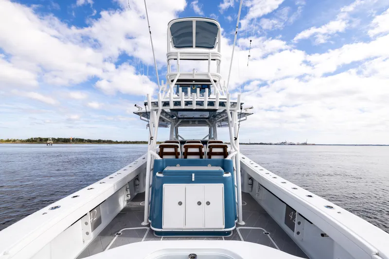 Slide: The Image of 2024 Yellowfin 42 Offshore boat on calm water under a blue sky. - 19