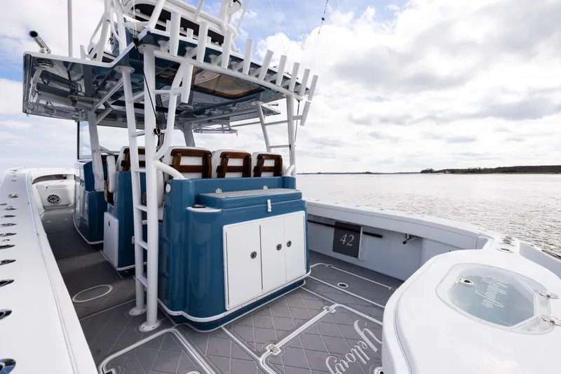Slide: The Image of 2024 Yellowfin 42 Offshore boat interior with seating and ocean view. - 21