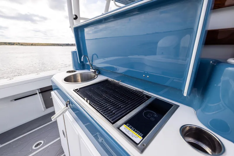 Slide: The Image of Outdoor kitchen on 2024 Yellowfin 42 Offshore boat with grill and sink. - 22