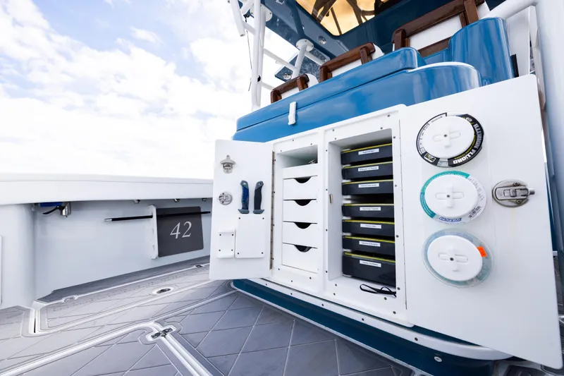 Slide: The Image of 2024 Yellowfin 42 Offshore boat with open storage compartments and fishing gear. - 23
