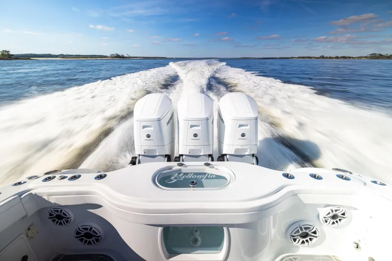 Slide: The Image of 2024 Yellowfin 42 Offshore boat speeding on open water, showcasing powerful engines. - 24