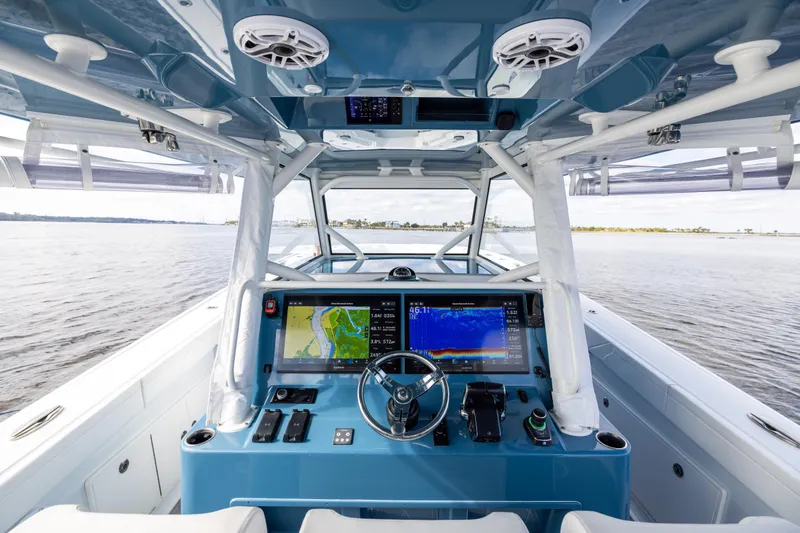 Slide: The Image of 2024 Yellowfin 42 Offshore boat cockpit with advanced navigation system on open water. - 26