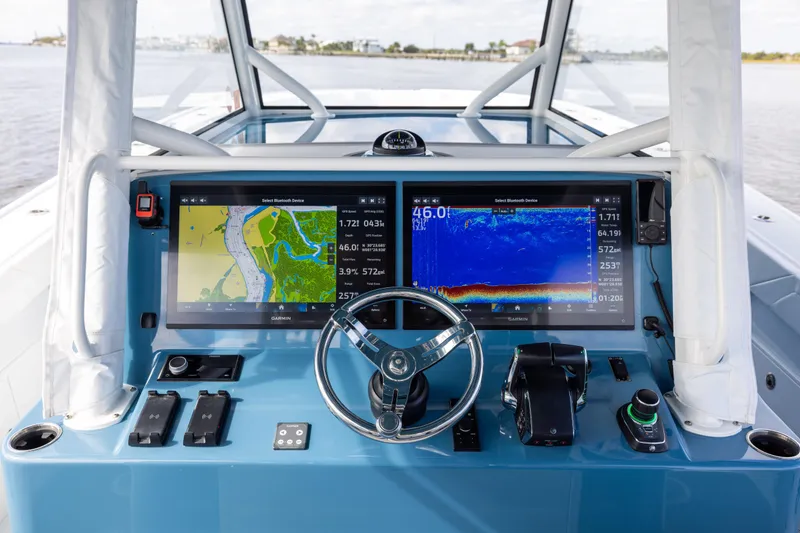 Slide: The Image of 2024 Yellowfin 42 Offshore boat dashboard with dual Garmin displays and steering wheel. - 27