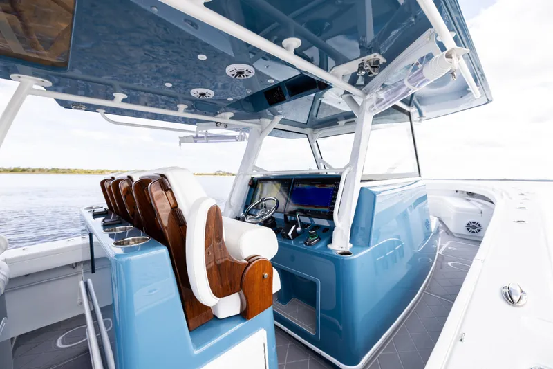 Slide: The Image of 2024 Yellowfin 42 Offshore boat interior with modern helm and seating. - 30