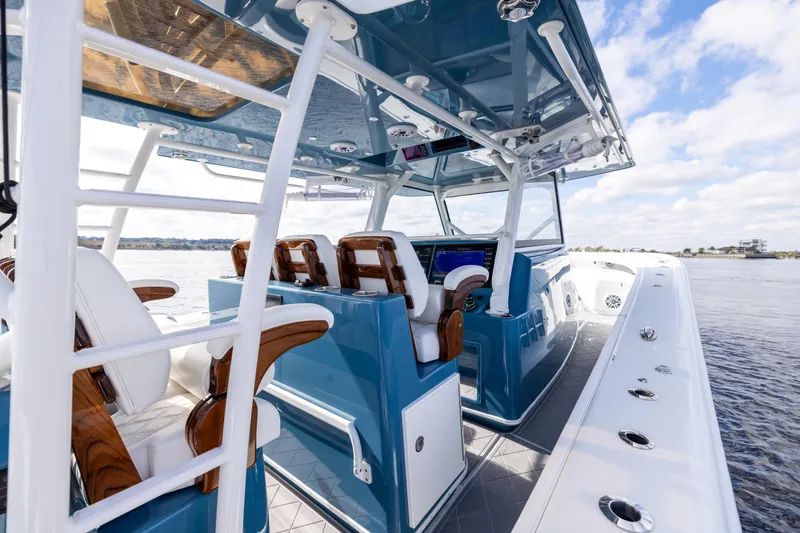 Slide: The Image of 2024 Yellowfin 42 Offshore boat interior with luxurious seating and advanced navigation system. - 36