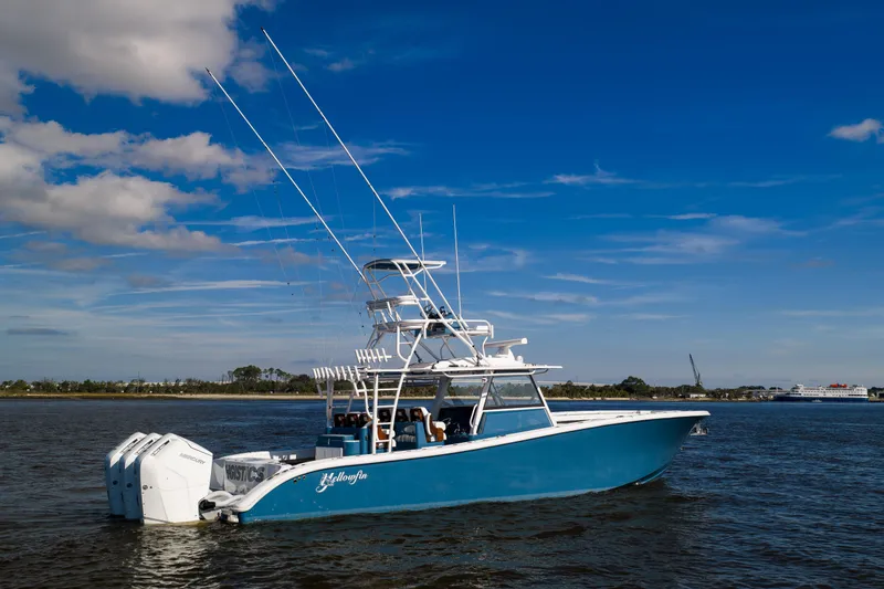 Slide: The Image of 2024 Yellowfin 42 Offshore boat cruising on a sunny day with clear blue skies. - 4