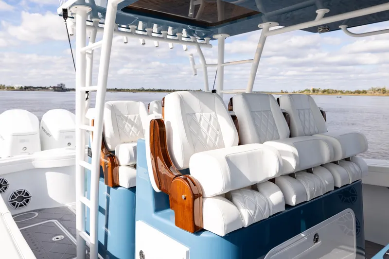 Slide: The Image of 2024 Yellowfin 42 Offshore boat with luxurious white seating and ocean backdrop. - 44