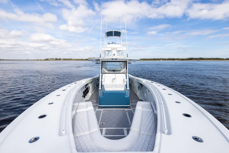 Slide: The Image of 2024 Yellowfin 42 Offshore boat on calm water under a blue sky. - 46