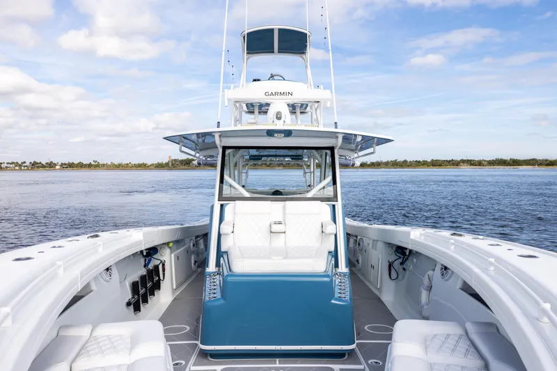 Slide: The Image of 2024 Yellowfin 42 Offshore boat on calm water, featuring spacious deck and advanced navigation. - 47