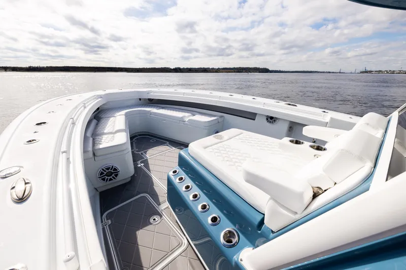 Slide: The Image of 2024 Yellowfin 42 Offshore boat interior with luxurious seating and ocean view. - 49