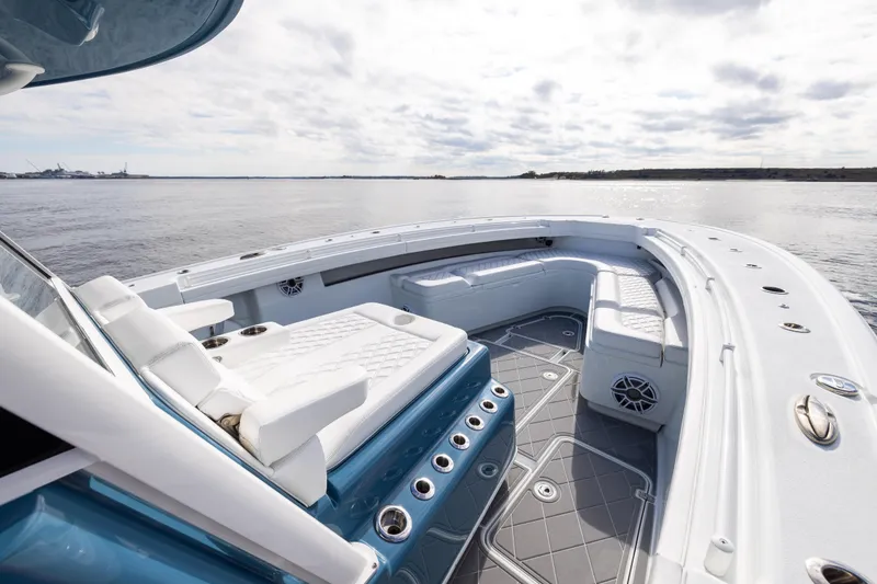 Slide: The Image of 2024 Yellowfin 42 Offshore boat interior with luxurious seating and ocean view. - 50
