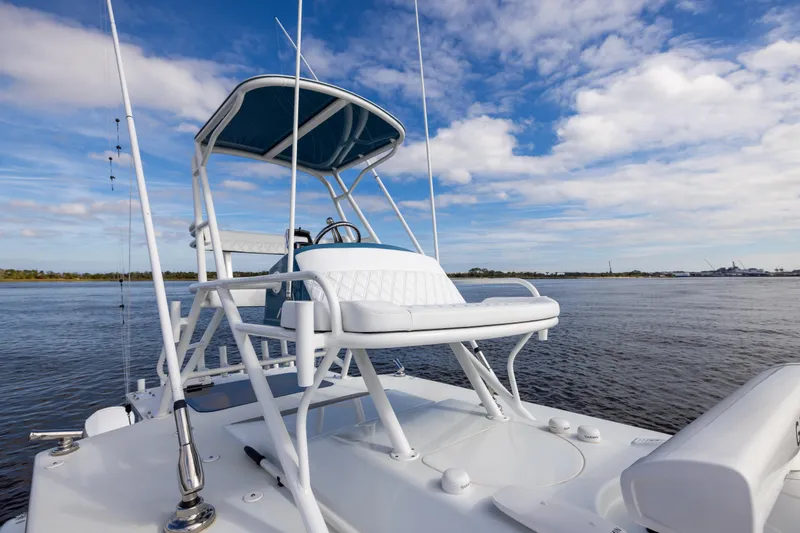 Slide: The Image of 2024 Yellowfin 42 Offshore boat on calm water under a blue sky. - 55