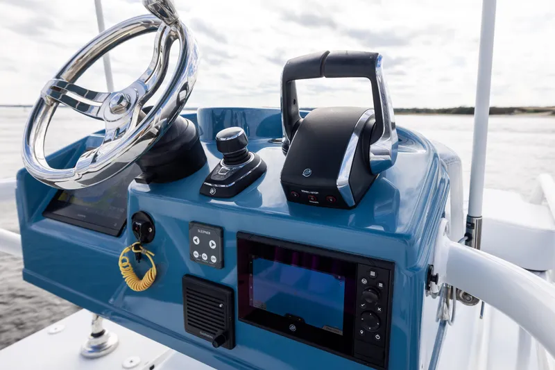 Slide: The Image of 2024 Yellowfin 42 Offshore boat helm with steering wheel and controls. - 59