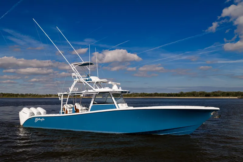 Slide: The Image of 2024 Yellowfin 42 Offshore boat on calm water under blue sky. - 6