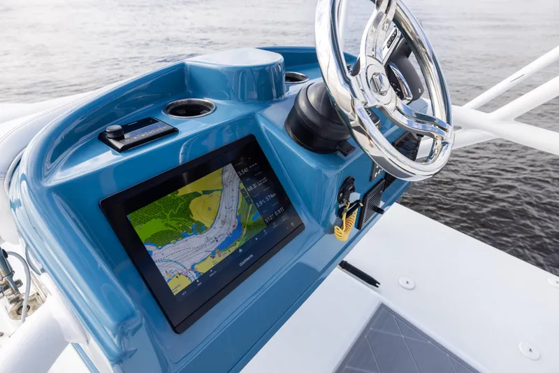 Slide: The Image of 2024 Yellowfin 42 Offshore boat dashboard with navigation display and steering wheel. - 60