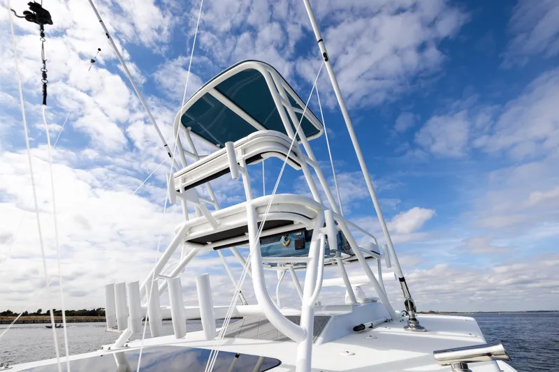 Slide: The Image of 2024 Yellowfin 42 Offshore boat tower against a blue sky with clouds. - 64