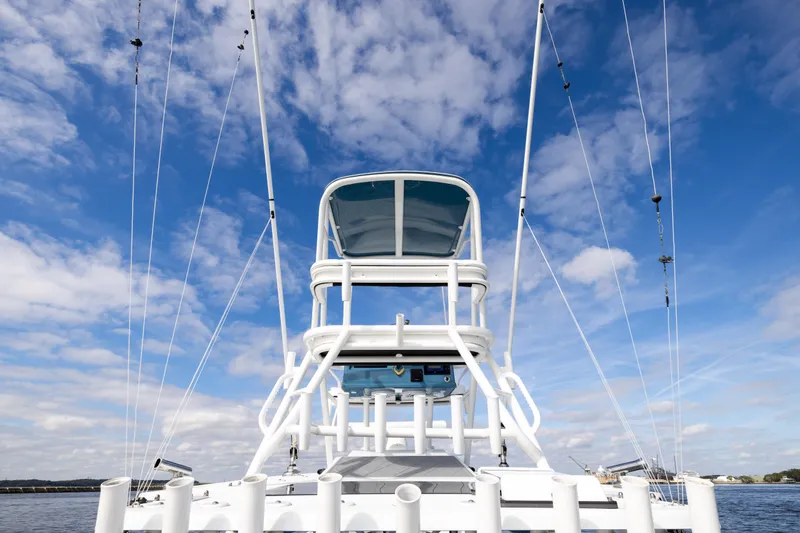 Slide: The Image of 2024 Yellowfin 42 Offshore boat tower against a blue sky with clouds. - 66